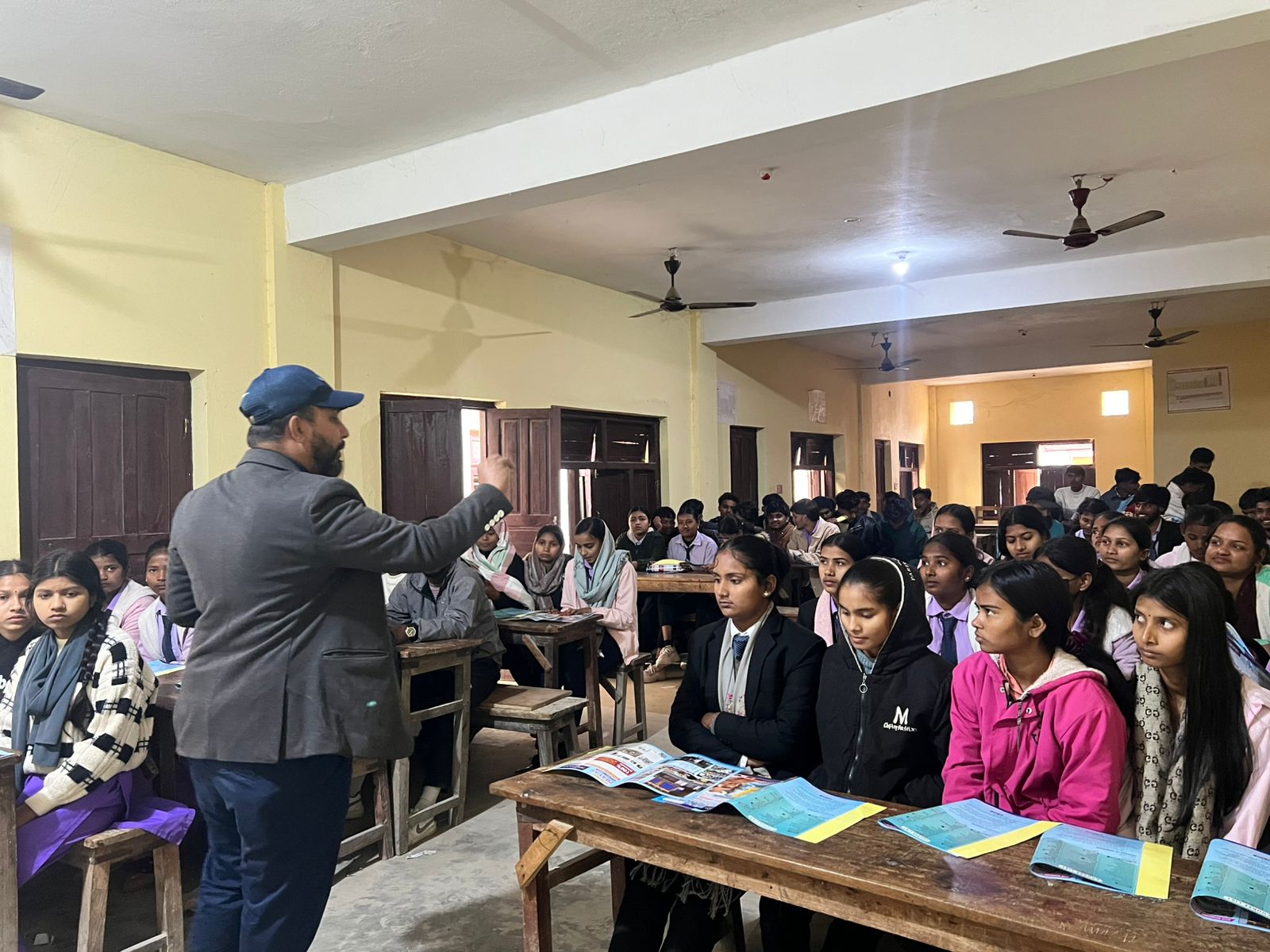 A CMF counselor addressing a hall full of students during a Mission Prayas career-counseling session