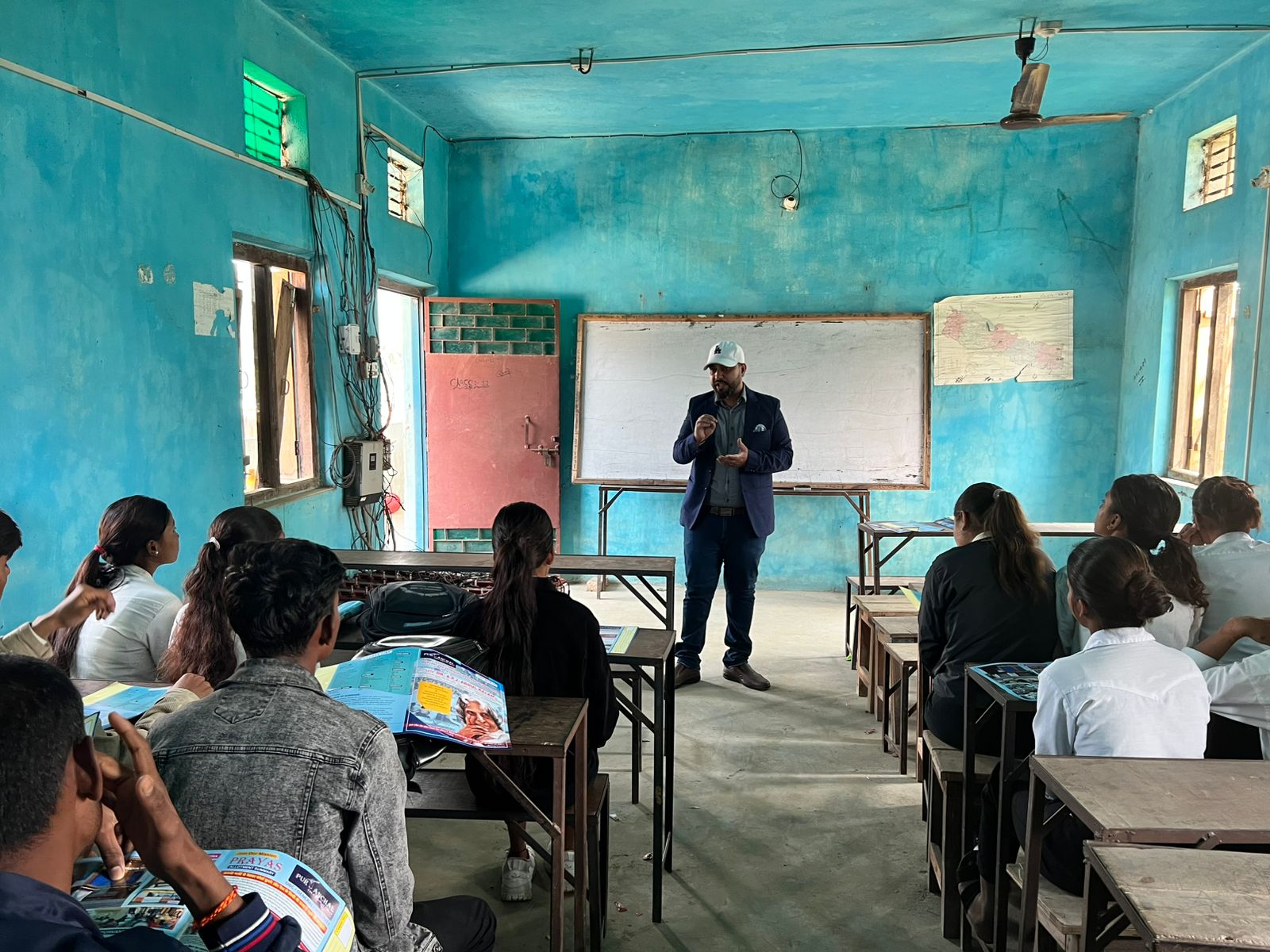 Counselor explaining career options at a whiteboard with a Nepal map on the wall