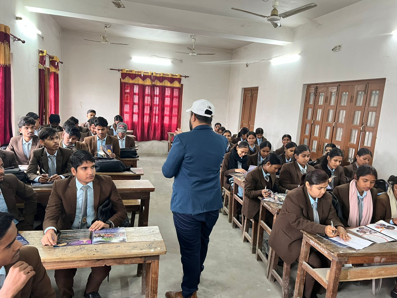 Large mixed classroom of uniformed students during a Mission Prayas school visit